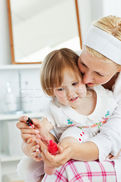 Charming mother making her little daughter's nails in the bathroom Stock photo © wavebreak_media