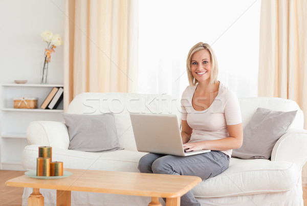 Beautiful woman with a laptop looking at the camera Stock photo © wavebreak_media