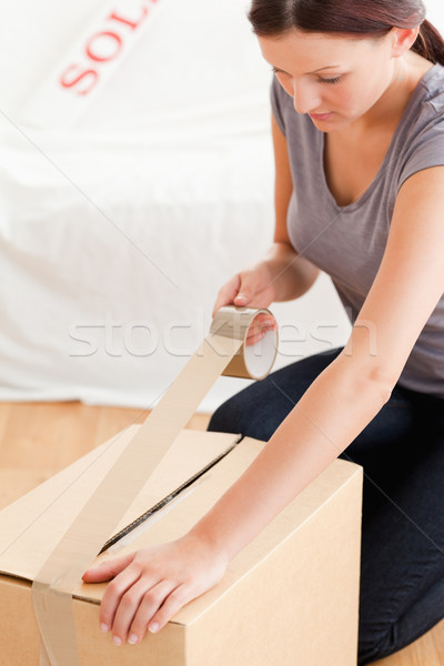 A woman prepares a cardboard for transport Stock photo © wavebreak_media