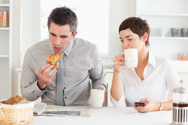 Stock photo: A cheerful couple is having breakfast together