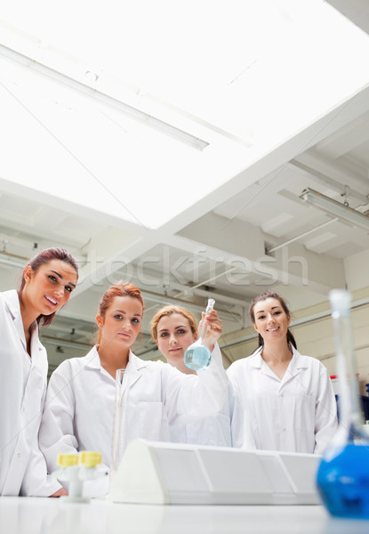 Portrait of chemistry students holding a flask while looking at the camera Stock photo © wavebreak_media