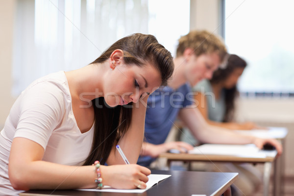 Studious woman writing in a classroom Stock photo © wavebreak_media