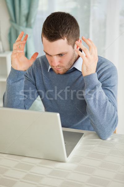 Young businessman angry about his laptop in his homeoffice Stock photo © wavebreak_media