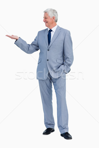 Businessman presenting with hand against white background Stock photo © wavebreak_media