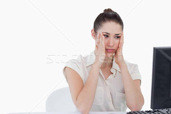 Worried businesswoman using a computer against a white background Stock photo © wavebreak_media