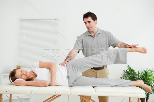 Physical therapist checking the pelvis of a woman in a medical room Stock photo © wavebreak_media