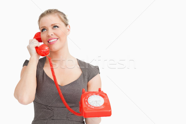 Woman calling with someone at the phone against white background Stock photo © wavebreak_media
