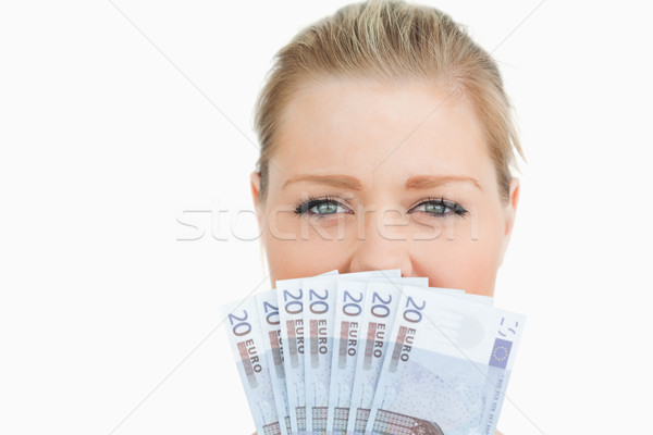 Woman hiding her mouse with her euros banknotes against white background Stock photo © wavebreak_media