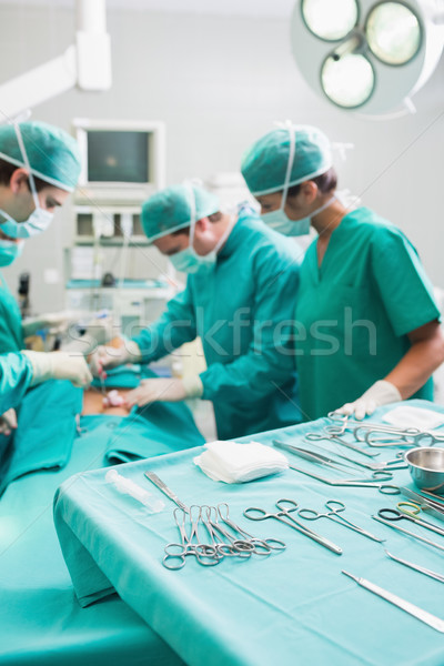 Surgical tools on a surgical tray while surgeons are operating Stock photo © wavebreak_media