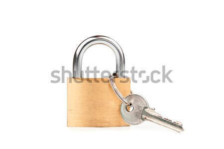 Padlock standing with  key hanging against white background Stock photo © wavebreak_media