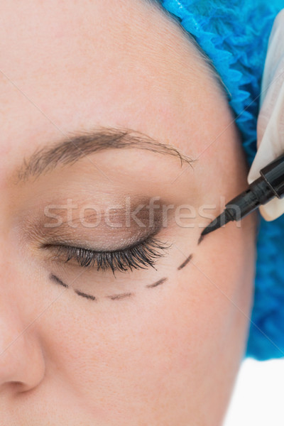 Doctor drawing around eye of woman Stock photo © wavebreak_media
