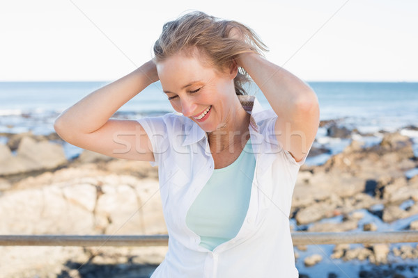 Stock photo: Casual woman smiling by the sea 