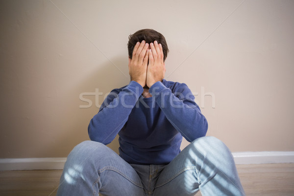 Depressed man sitting on floor Stock photo © wavebreak_media