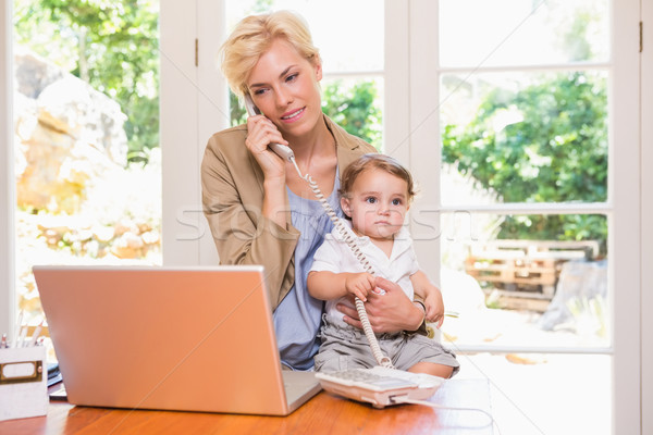 Pretty blonde woman with his son phoning and using laptop  Stock photo © wavebreak_media