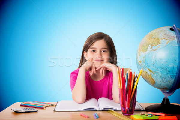 Composite image of cute pupil working at her desk Stock photo © wavebreak_media