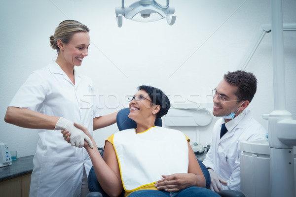 Male dentist with assistant shaking hands with woman Stock photo © wavebreak_media