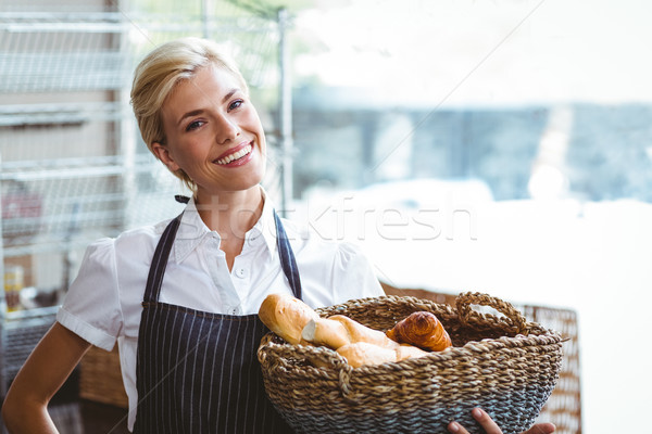 Stock photo:  Pretty waitress carrying basket of bread