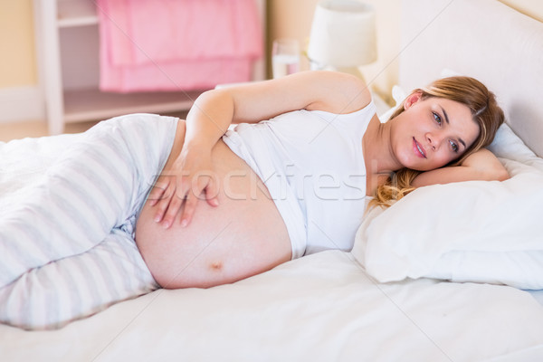 Pregnant woman lying on bed  Stock photo © wavebreak_media