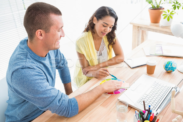 Stock photo: Smiling colleagues using colour wheel 