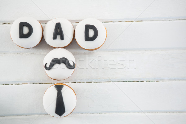 Overhead view of cupcakes with text on white table Stock photo © wavebreak_media