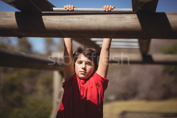 Portrait of boy exercising on monkey bar during obstacle course Stock photo © wavebreak_media