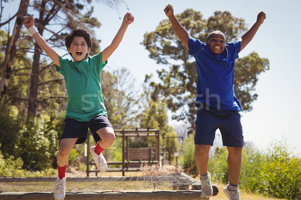 Stock photo: Happy friends cheering on obstacle during obstacle course