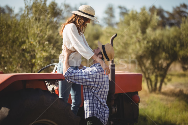 Young couple looking at each other while standing by tractor Stock photo © wavebreak_media