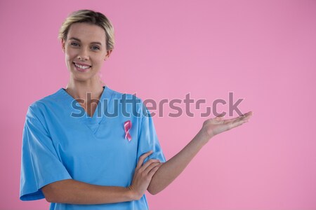 Portrait of smiling female doctor in scrubs gesturing Stock photo © wavebreak_media