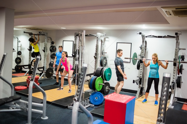 S'adapter personnes travaillant sur poids chambre gymnase [[stock_photo]] © wavebreak_media