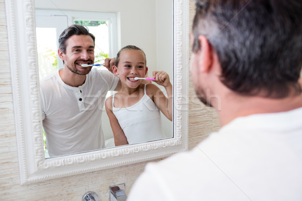 Father and daughter brushing their teeth in the bathroom Stock photo © wavebreak_media
