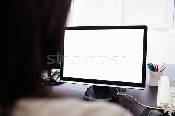 Stock photo:  Casual businesswoman working on laptop 