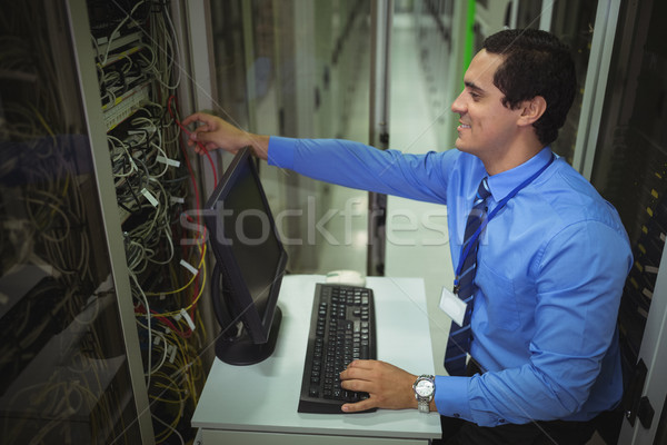 Technician working on personal computer while analyzing server Stock photo © wavebreak_media