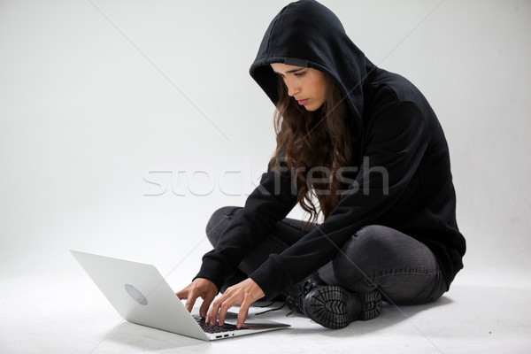 Stock photo: Hacker using a laptop