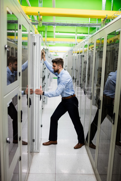 Technician adjusting server cabinet Stock photo © wavebreak_media