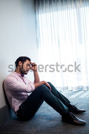 Worried doctor sitting on floor Stock photo © wavebreak_media