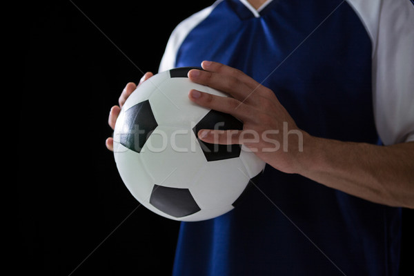 Mid-section of football player holding football with both hands Stock photo © wavebreak_media