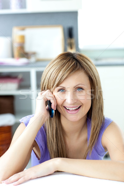 Cheerful woman answering the phone in the kitchen  Stock photo © wavebreak_media