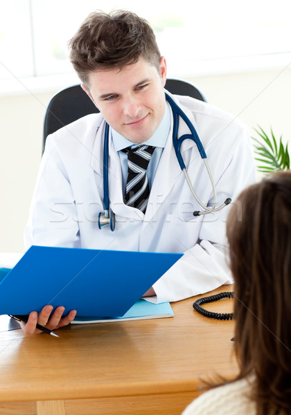 Self-assured doctor reading a report with a female patient Stock photo © wavebreak_media