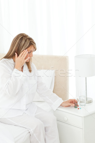 Woman having a headache on her bed Stock photo © wavebreak_media