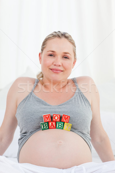 Pregnant woman with baby cubes on her belly at home Stock photo © wavebreak_media