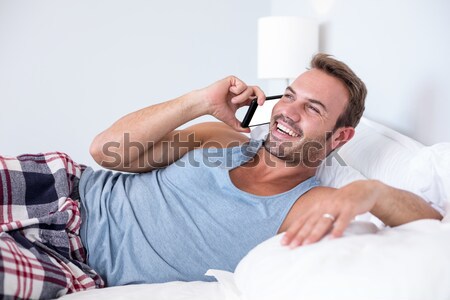 Stock photo: Man lying down on his bed