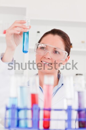 Beautiful red-haired woman holding a test tube in a lab Stock photo © wavebreak_media