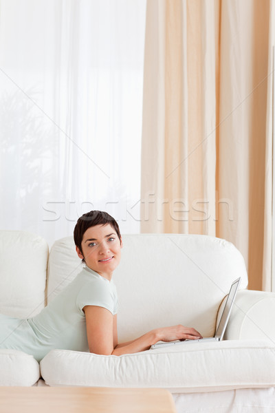 Portrait of a short-haired woman with a laptop while looking at the camera Stock photo © wavebreak_media