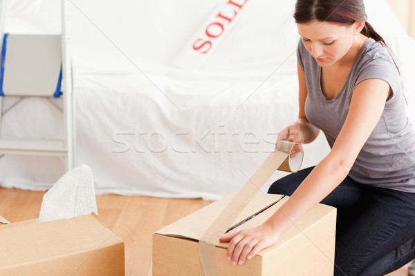 A woman closing a cardboard with tape Stock photo © wavebreak_media