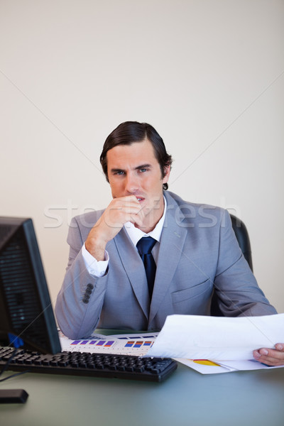 Young salesman thinking about statistics Stock photo © wavebreak_media