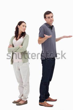 Man shrugged his shoulders back to back with woman against white background Stock photo © wavebreak_media