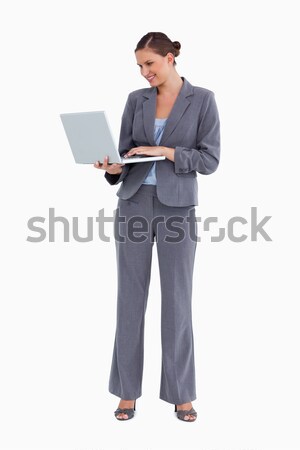 Smiling tradeswoman working on her laptop against a white background Stock photo © wavebreak_media