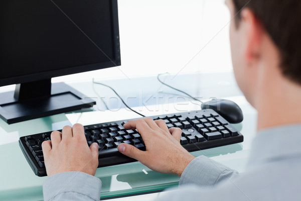 Back view of a manager working with a monitor in his office Stock photo © wavebreak_media