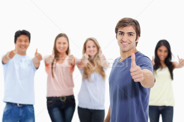 Stock photo: People smiling and approving with one of them in foreground against white background