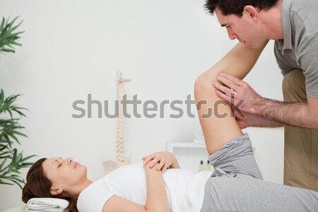 Woman lying while being massaged by her practitioner indoors Stock photo © wavebreak_media
